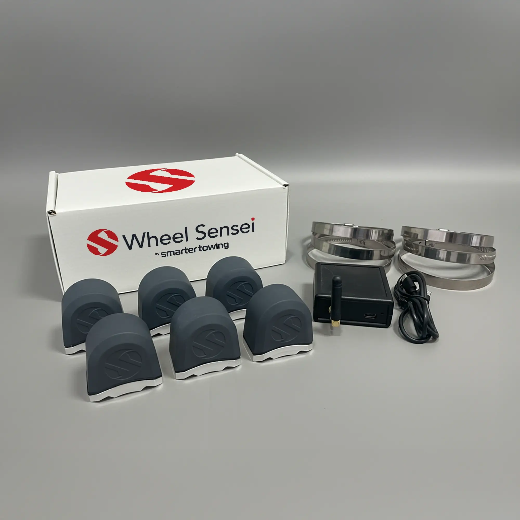 Triple Axle Wheel Sensei Smart Towing Kit by Smarter Towing — includes 6 x wheel sensei sensor units, ring clamps, data box, USB-C cable and activation code for real-time tyre pressure and bearing monitoring on trailers and caravans.